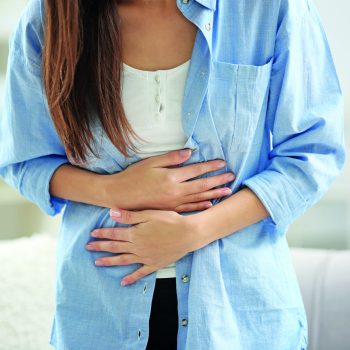 Young,Woman,Suffering,From,Abdominal,Pain,At,Home,,Closeup.,Gynecology